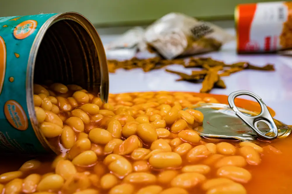 Baked beans pouring out of a can