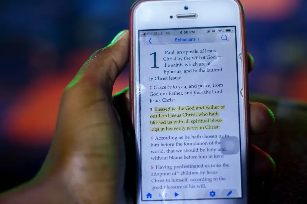 bible app in iPhone in a hand