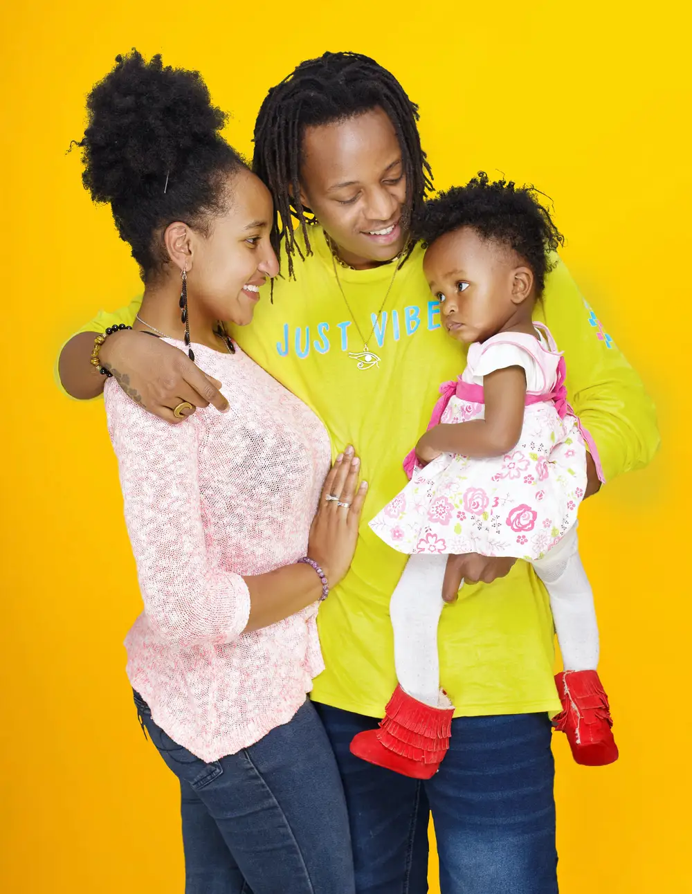 A young couple and their daughter in a photoshoot