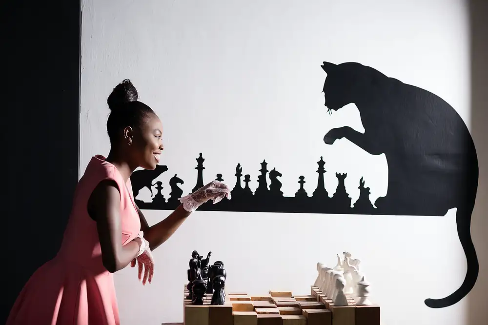 Lady on pink dress with a chess board