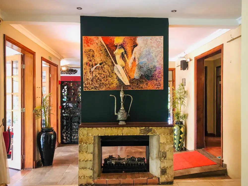 Framed painting over a fire place