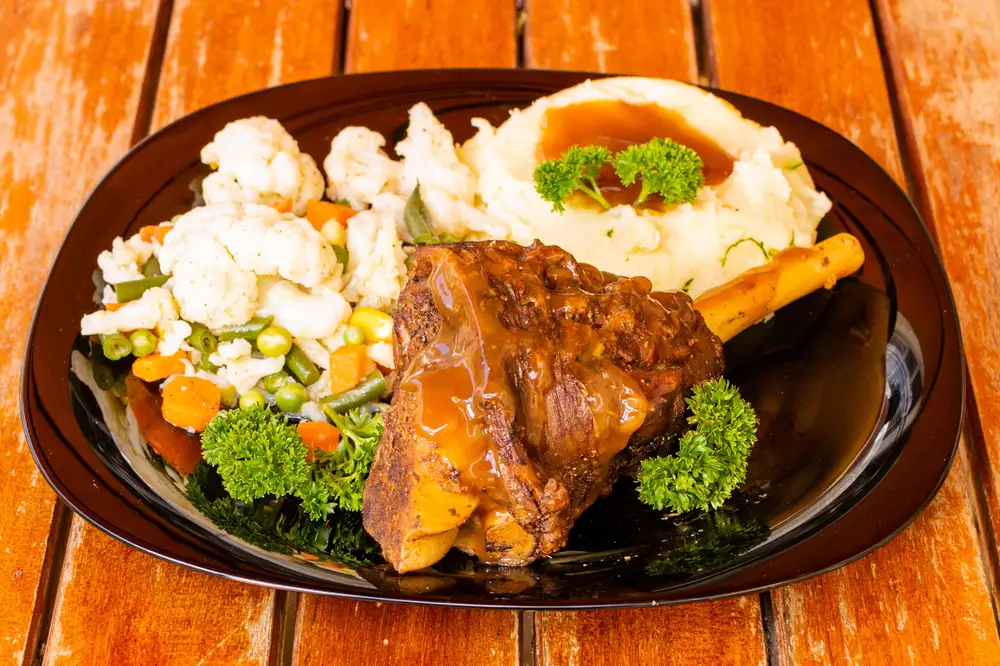 African tradisitonal dish served with fish sauce and vegetables