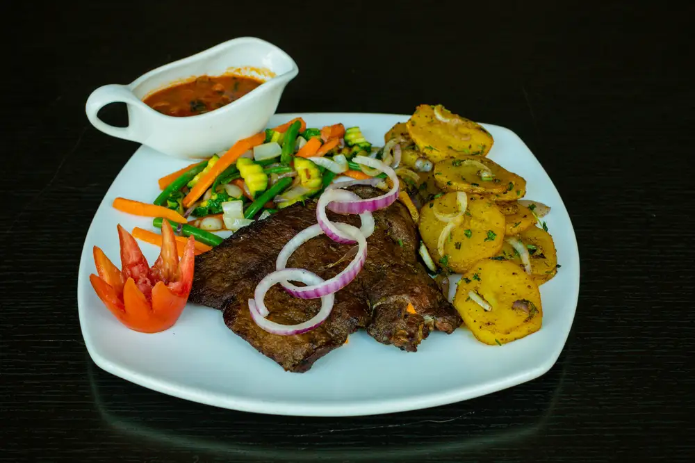 Grilled Beef garnished with vegetables and fruits