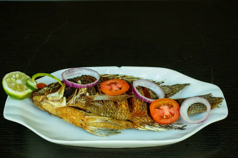Fried whole fish garnished with Vegetables