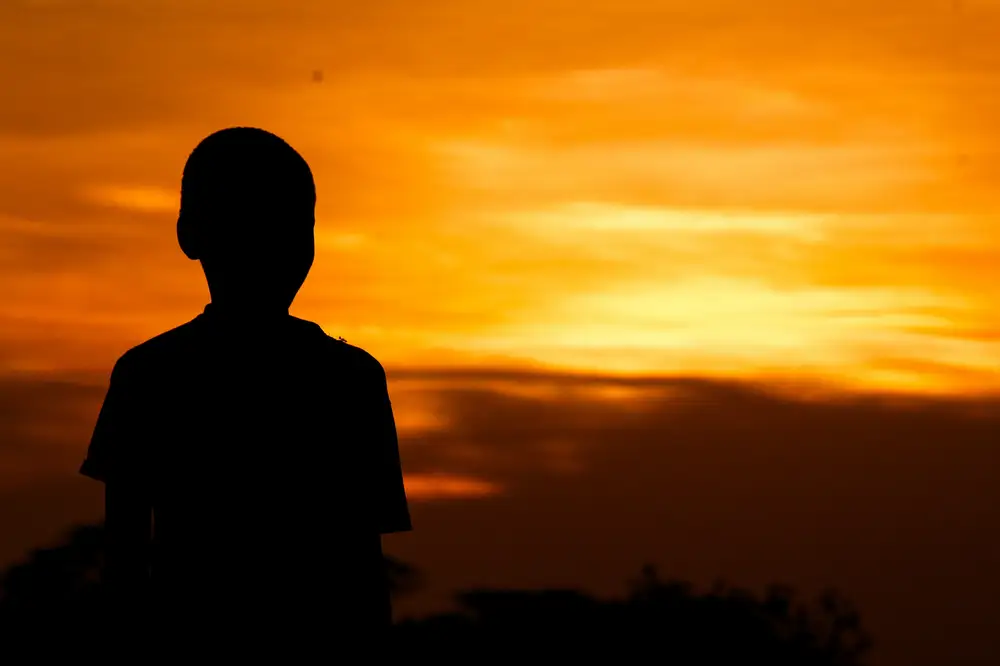 Child looking at the sunset