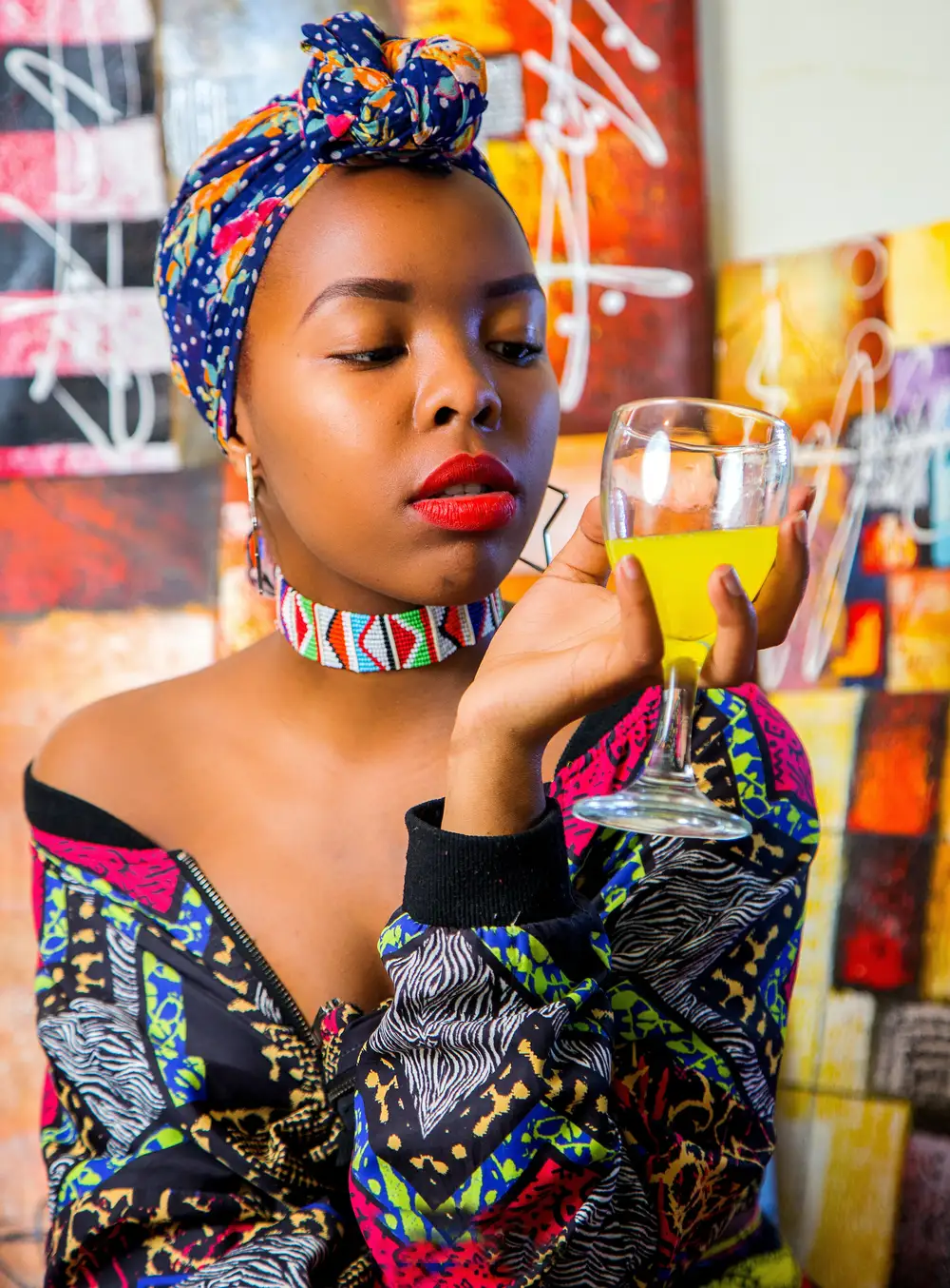 woman holding a glass of juice