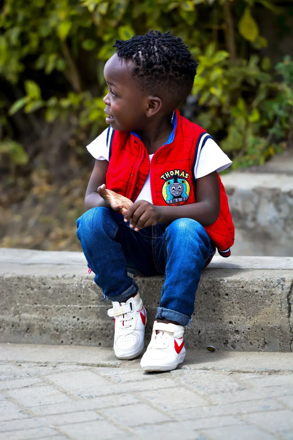 Child sitting on the sidewalk