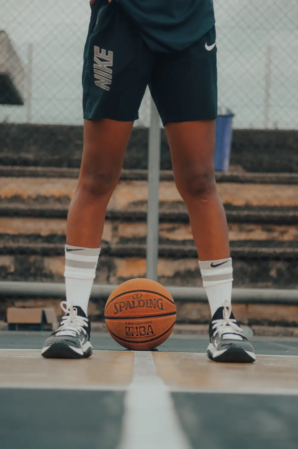 man standing behind a basketball on a court