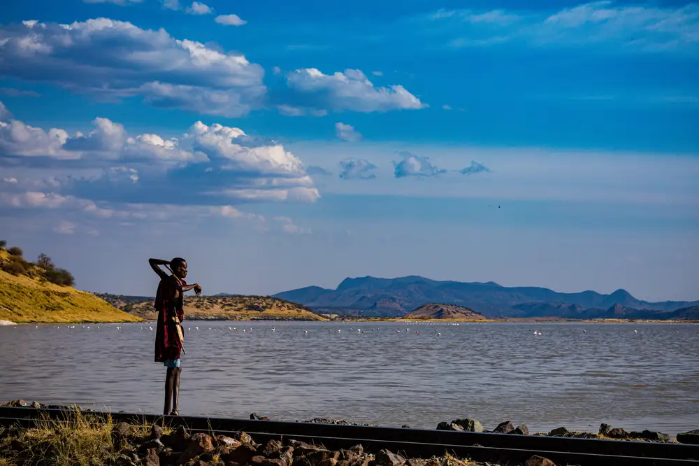 Sideview of indigenous man standing by a lake