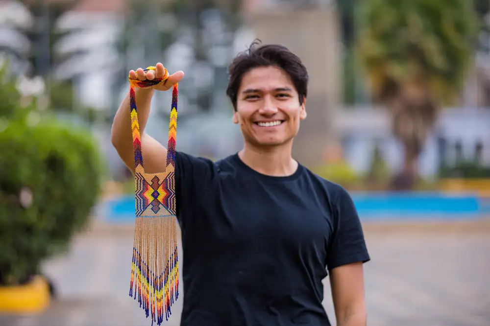 Young Man holding bead craft
