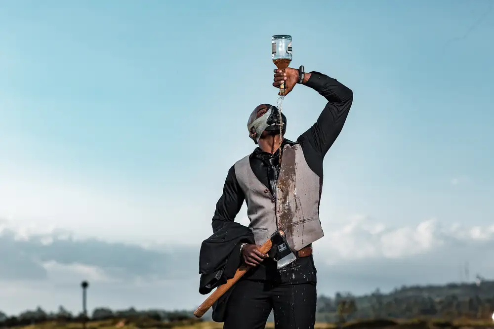 Man holding axe popping champagne