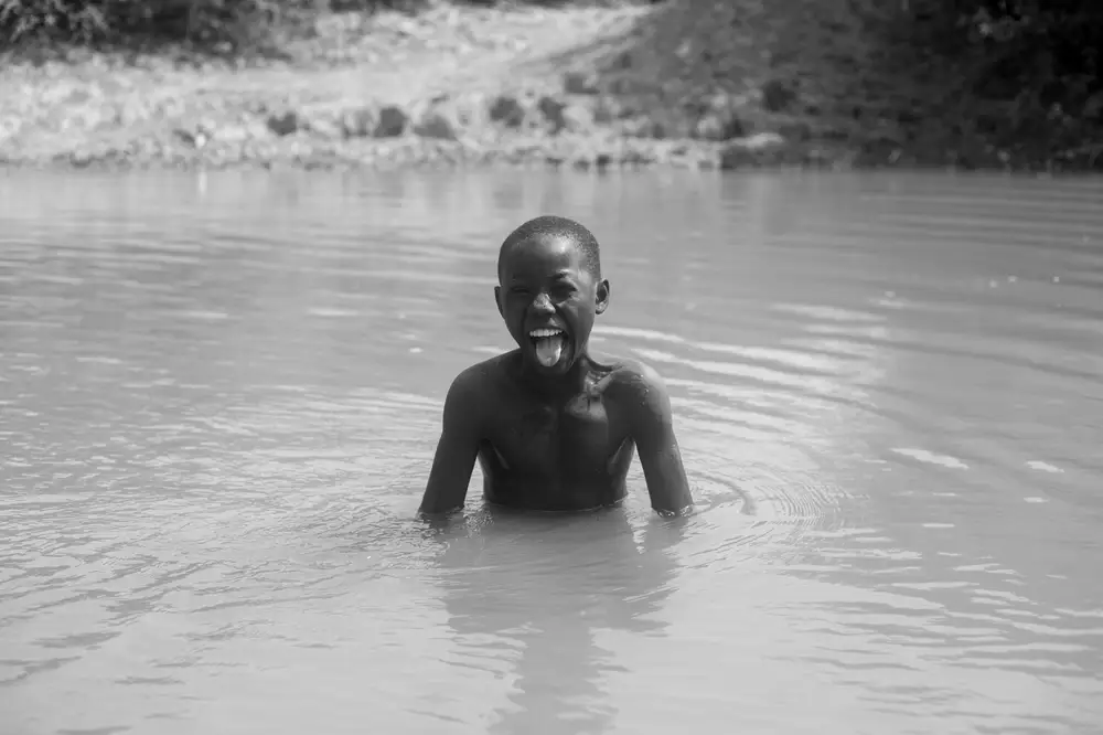 Boy swimming in a stream