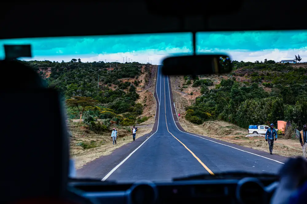 Picture of a long highway from inside a car