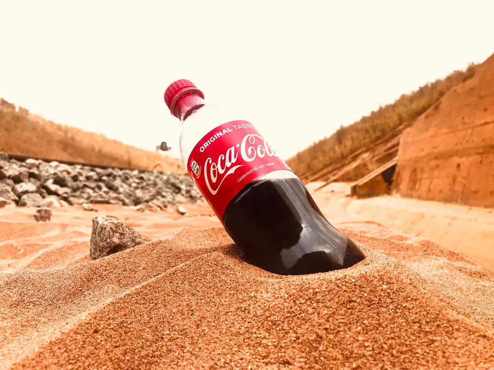 Bottle of cocacola in the sand
