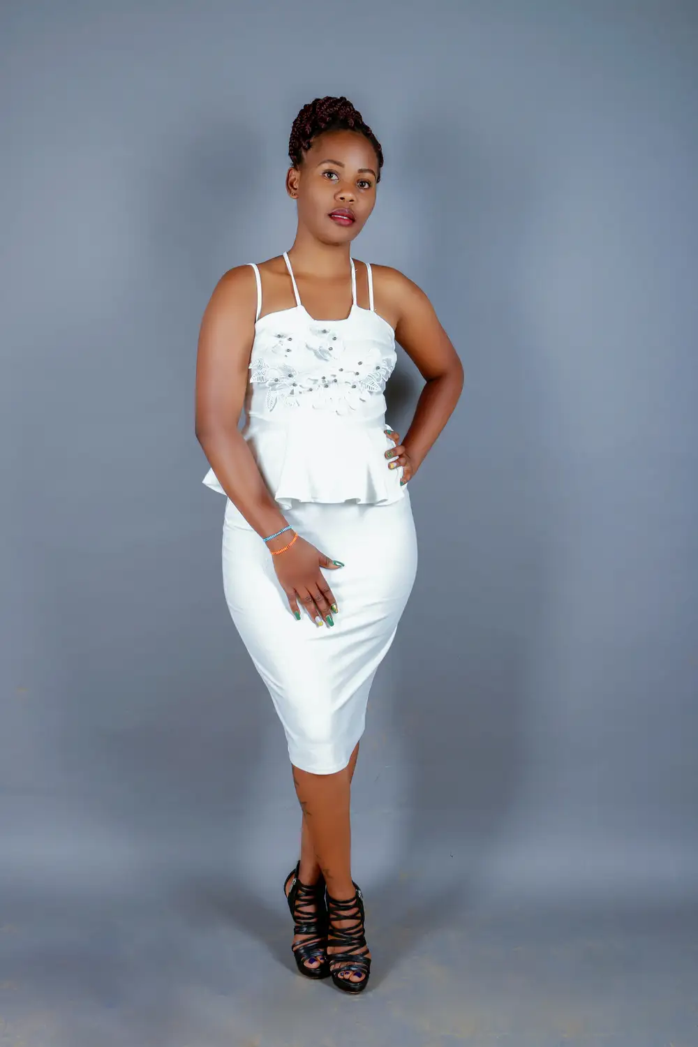 woman in a white outfit with left hand akinbo