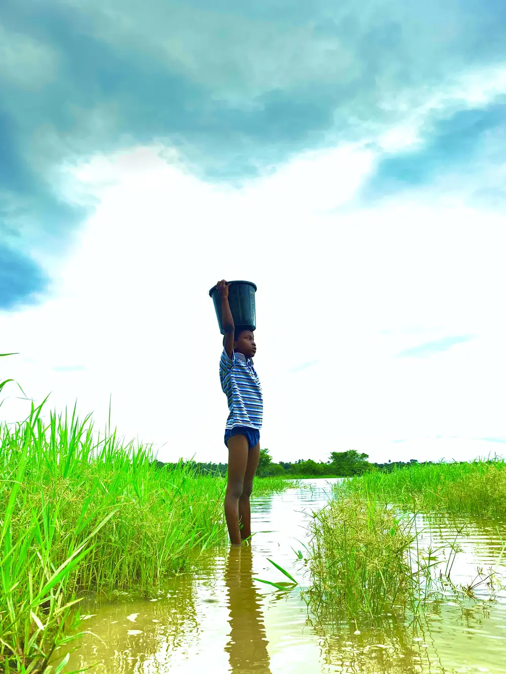 Boy Fetching Water at Eko Ende Inland Sea
