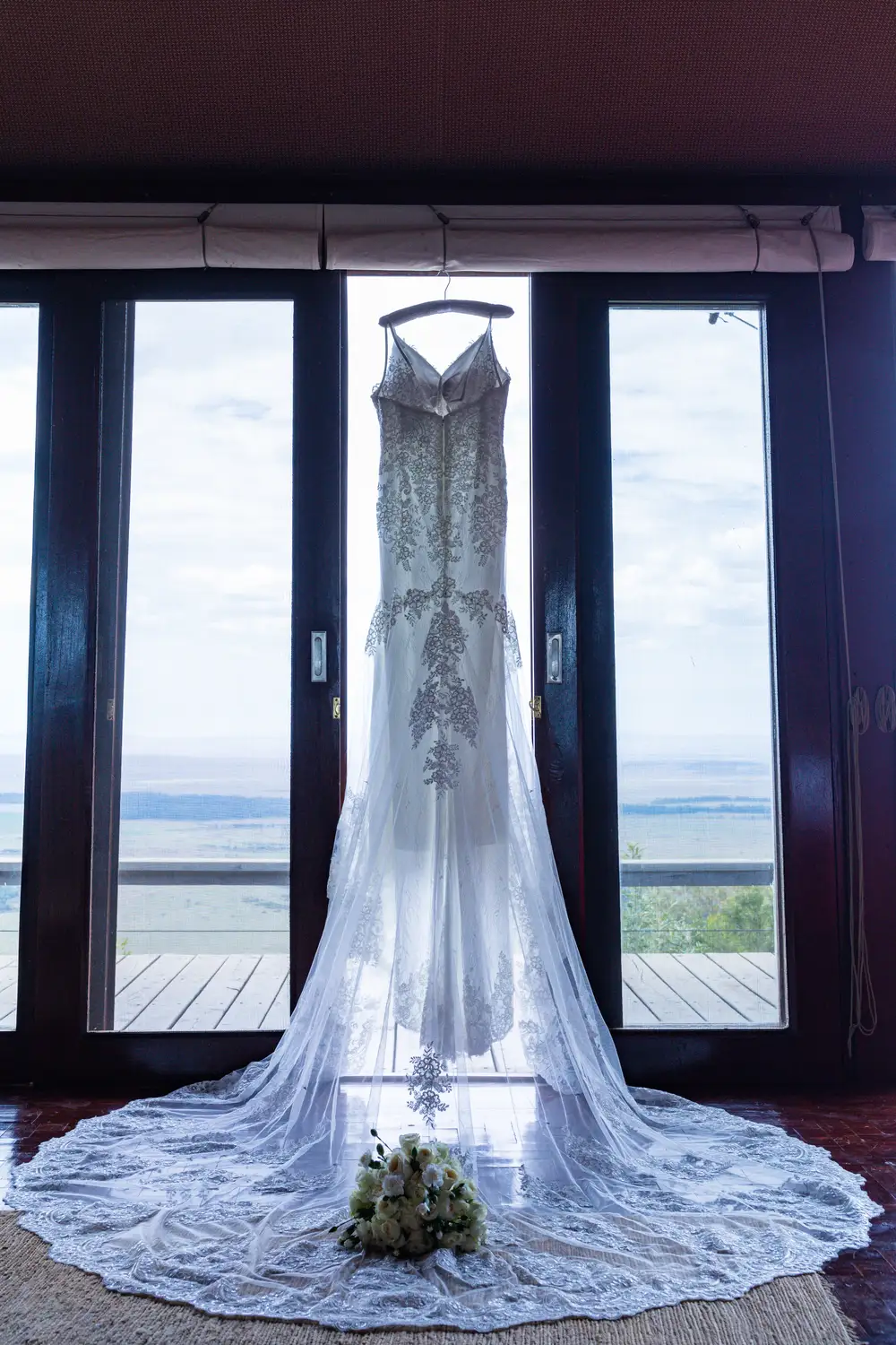 Elegant long white dress hung in a room