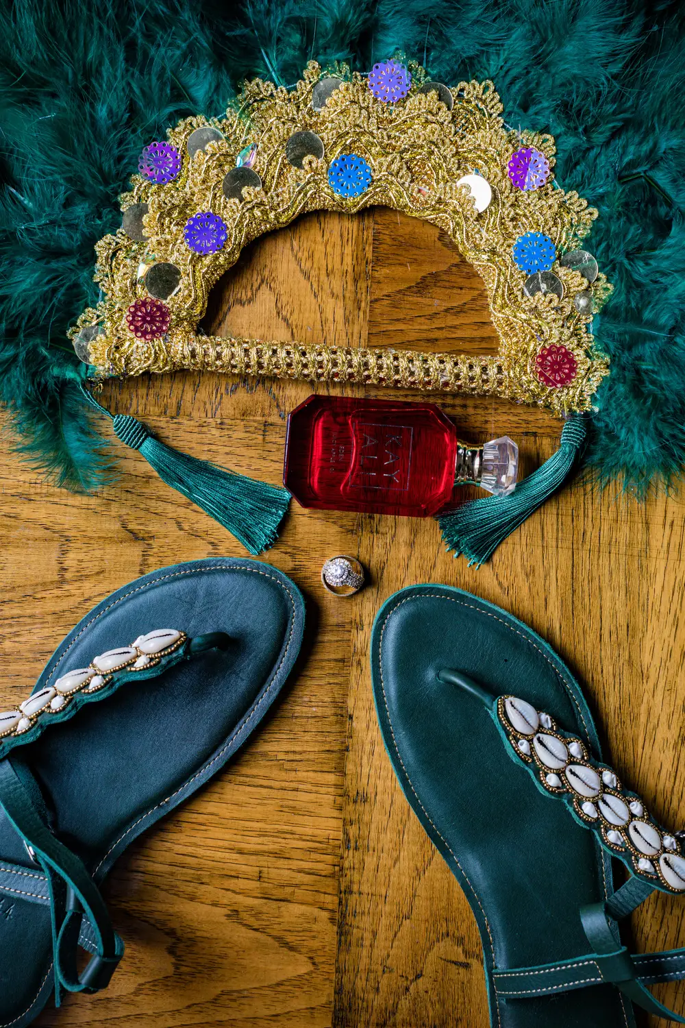 Leather shoes with a perfume bottle and green furry hand fan