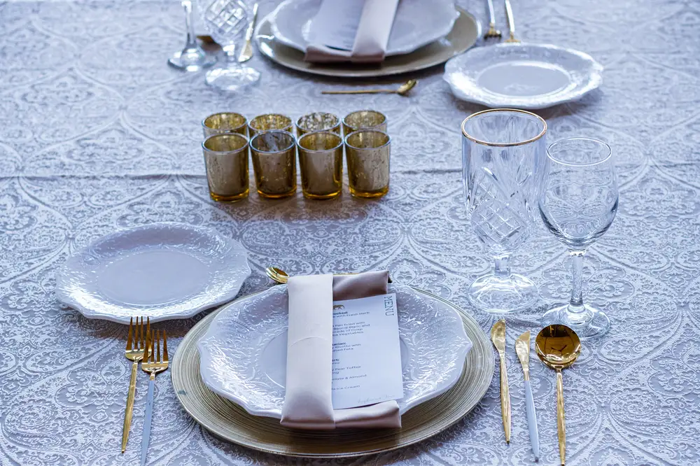 Glassware with golden cutlery and scented candles