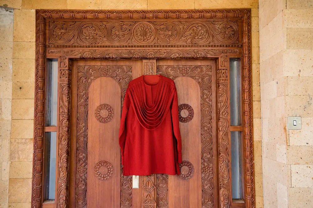 Men's Ceremonial attire hanging from a door