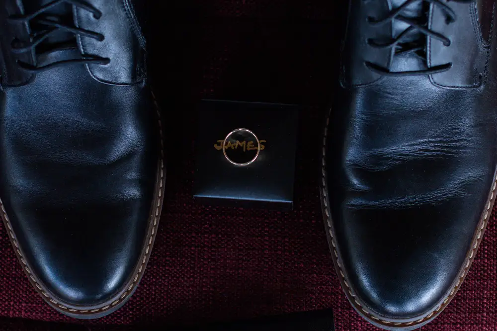 Black shoe and wedding ring