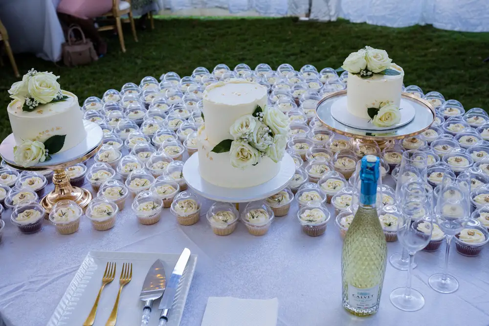 Weddingg Cakes and cupcakes with a bottle of Wiine
