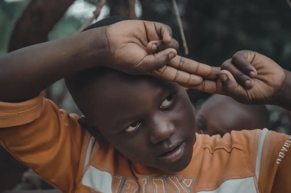 Boy making the peace sign with both hands