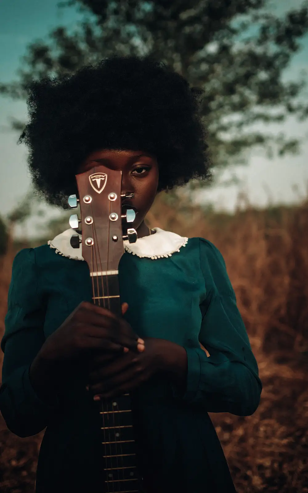 Afro lady holding a guitar