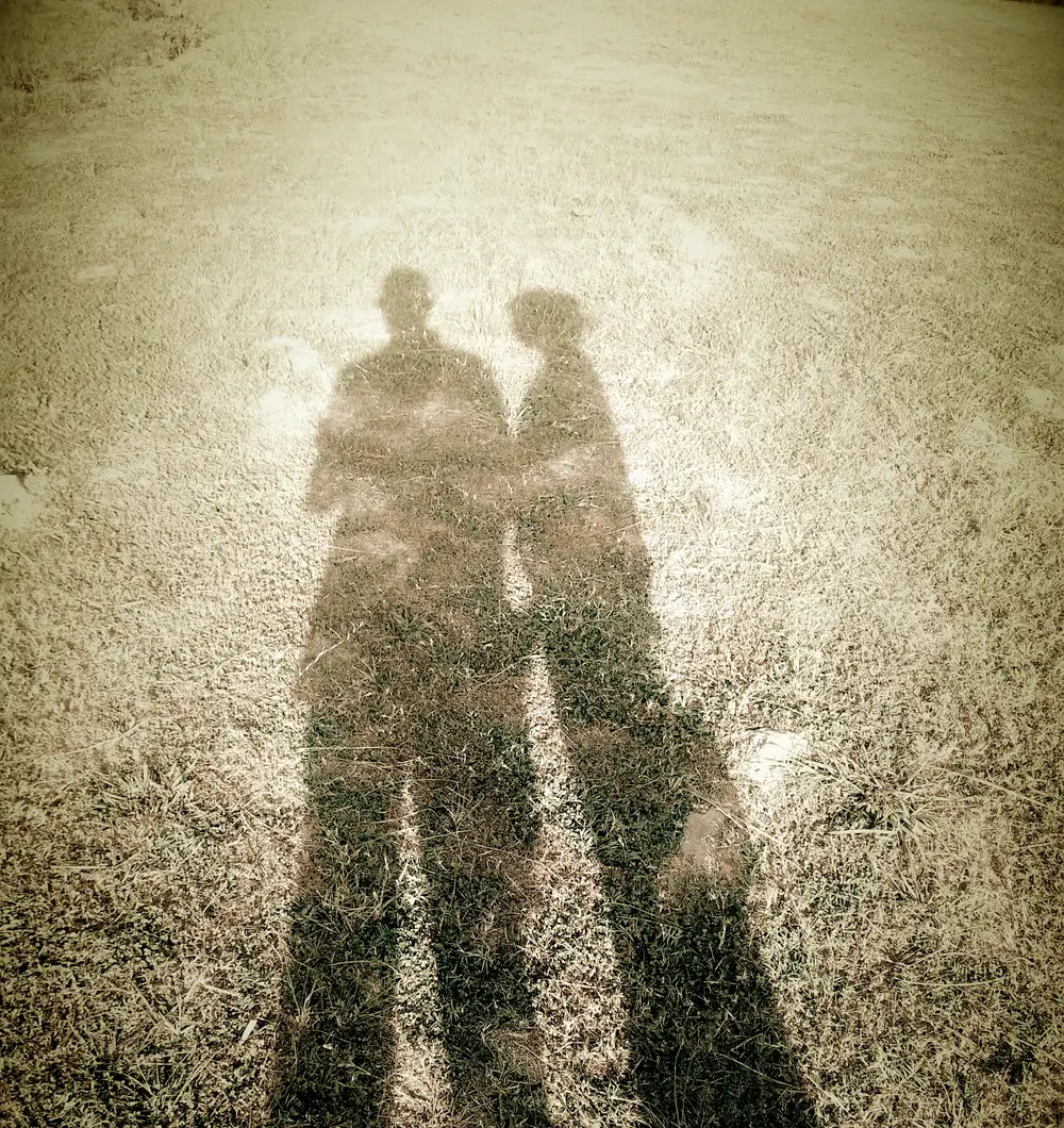 Shadows of a young couple standing