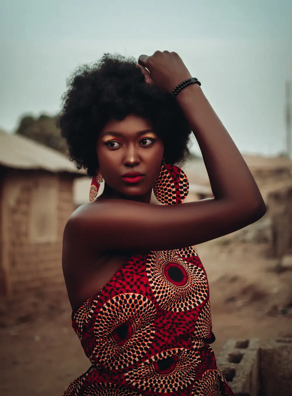 Indigenous lady with Afro hair wearing an African attire
