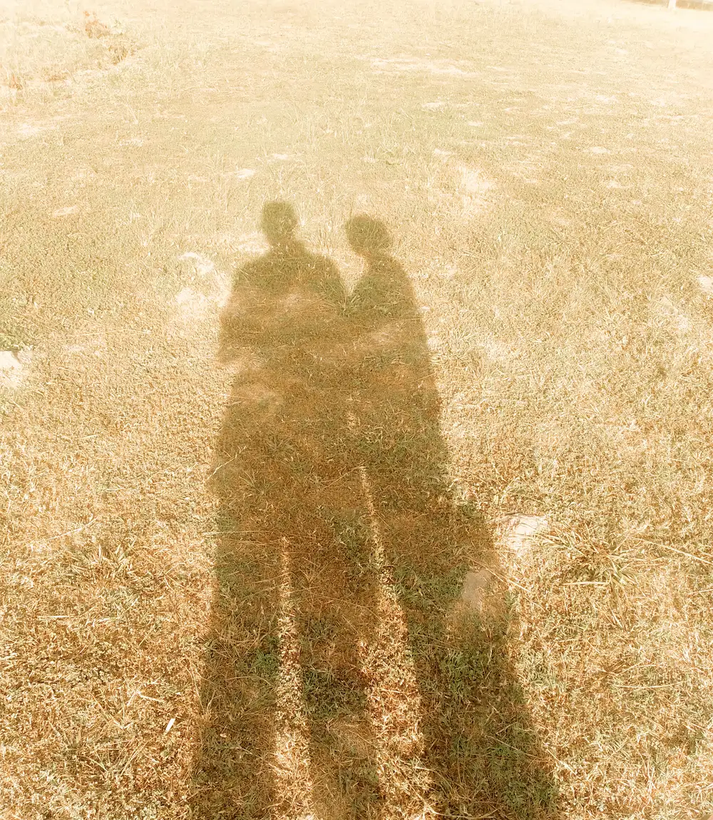 Shadow reflection of two people standing