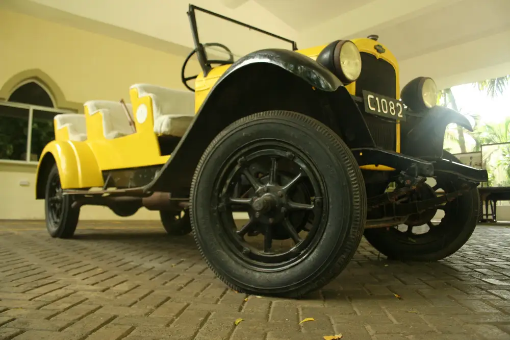 A yellow colored classic vehicle