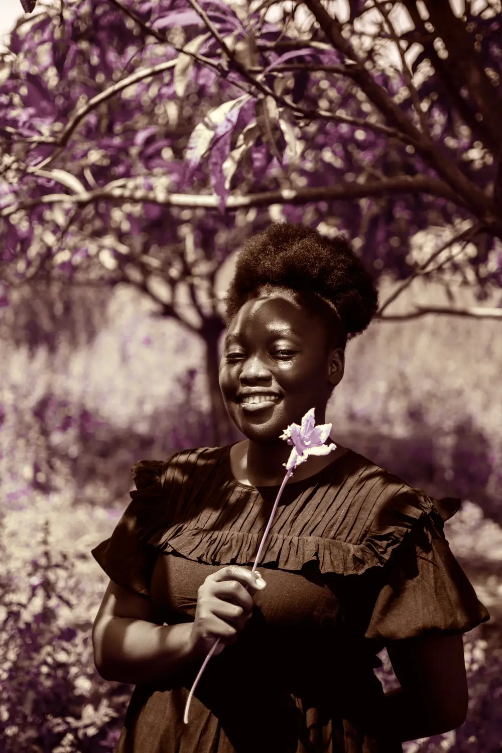 Lady smiling holding flower