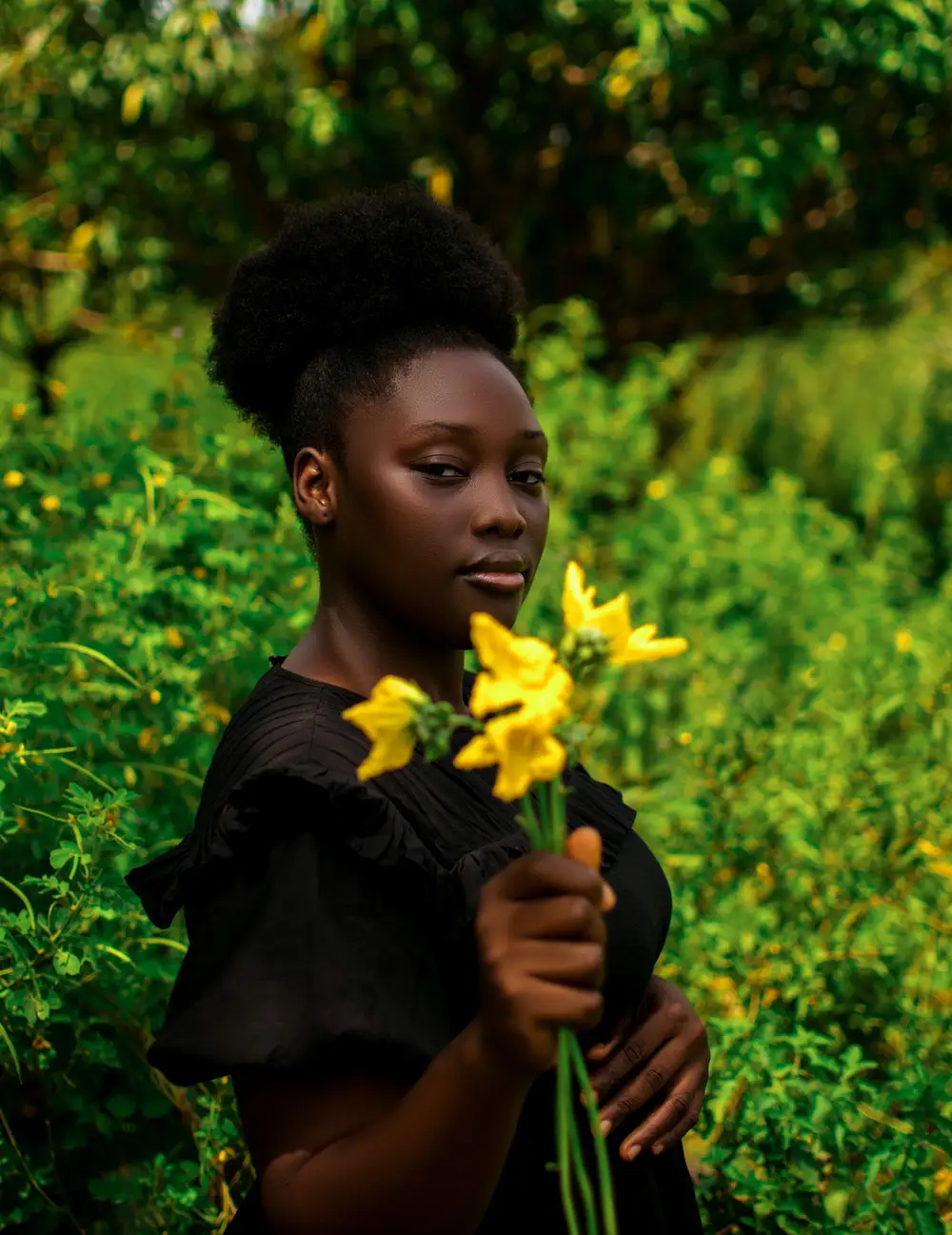 Lady on black gown holding flower