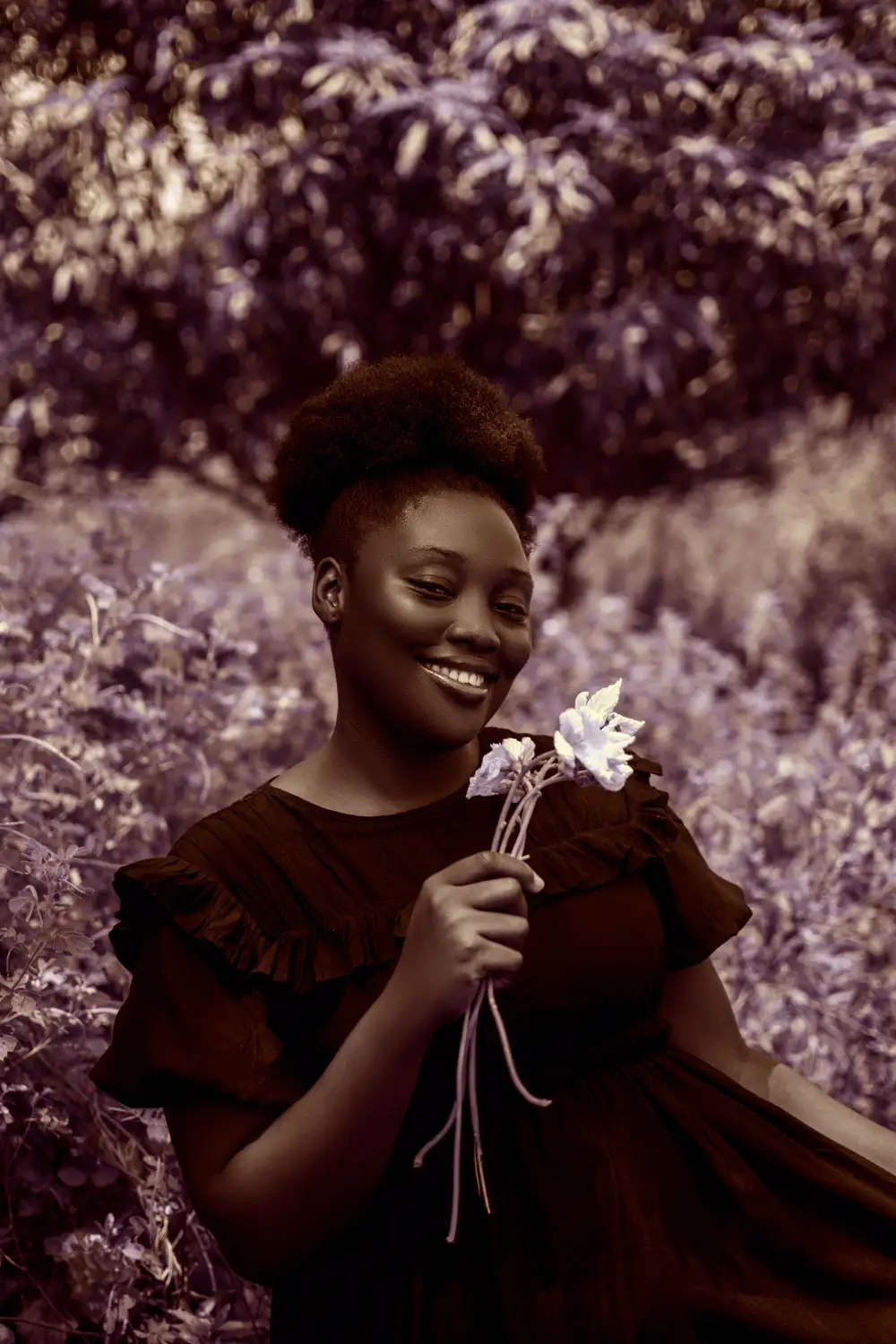 Lady smiling holding flower