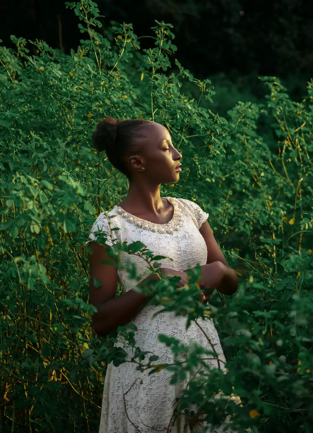 Lady on white standing with eyes closed