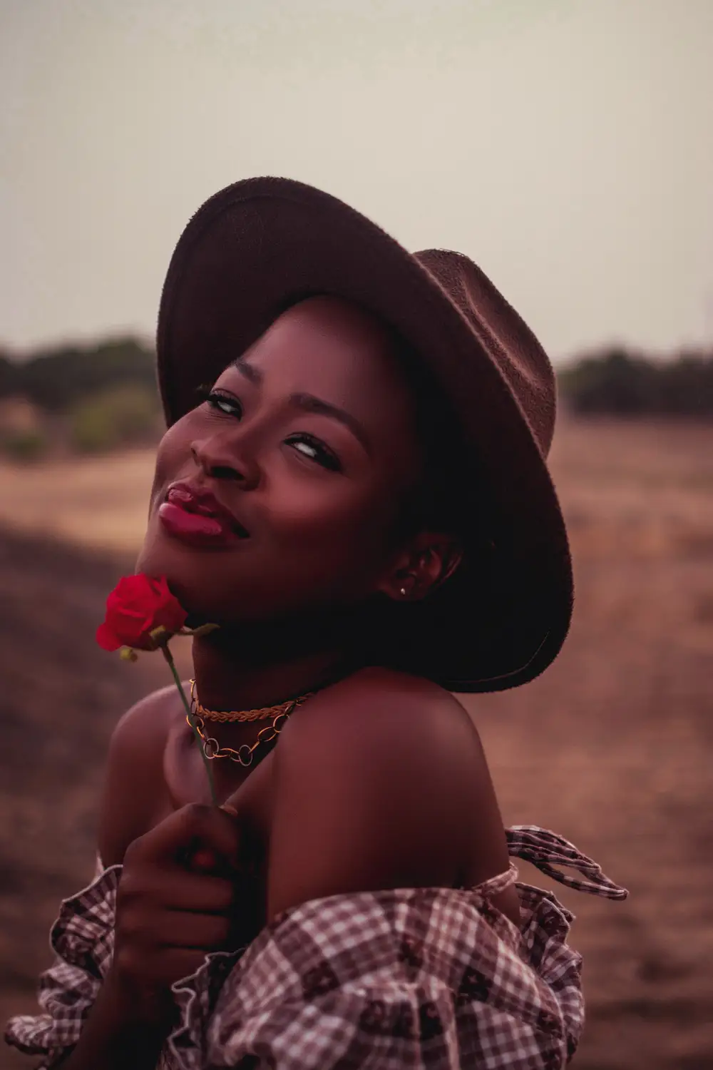 Lady holding rose and smilling