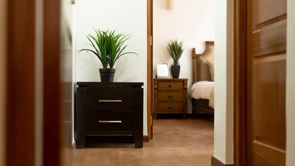 Brown wooden nightstand beside doorway inside room photo