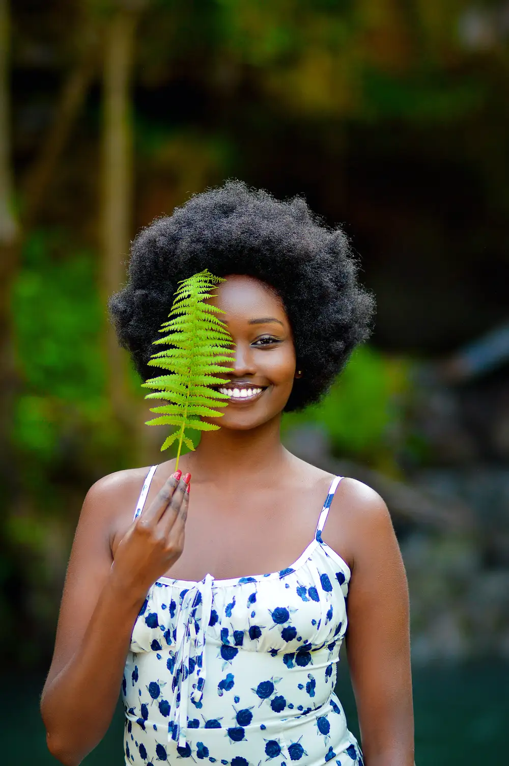 Smiling behind a fern