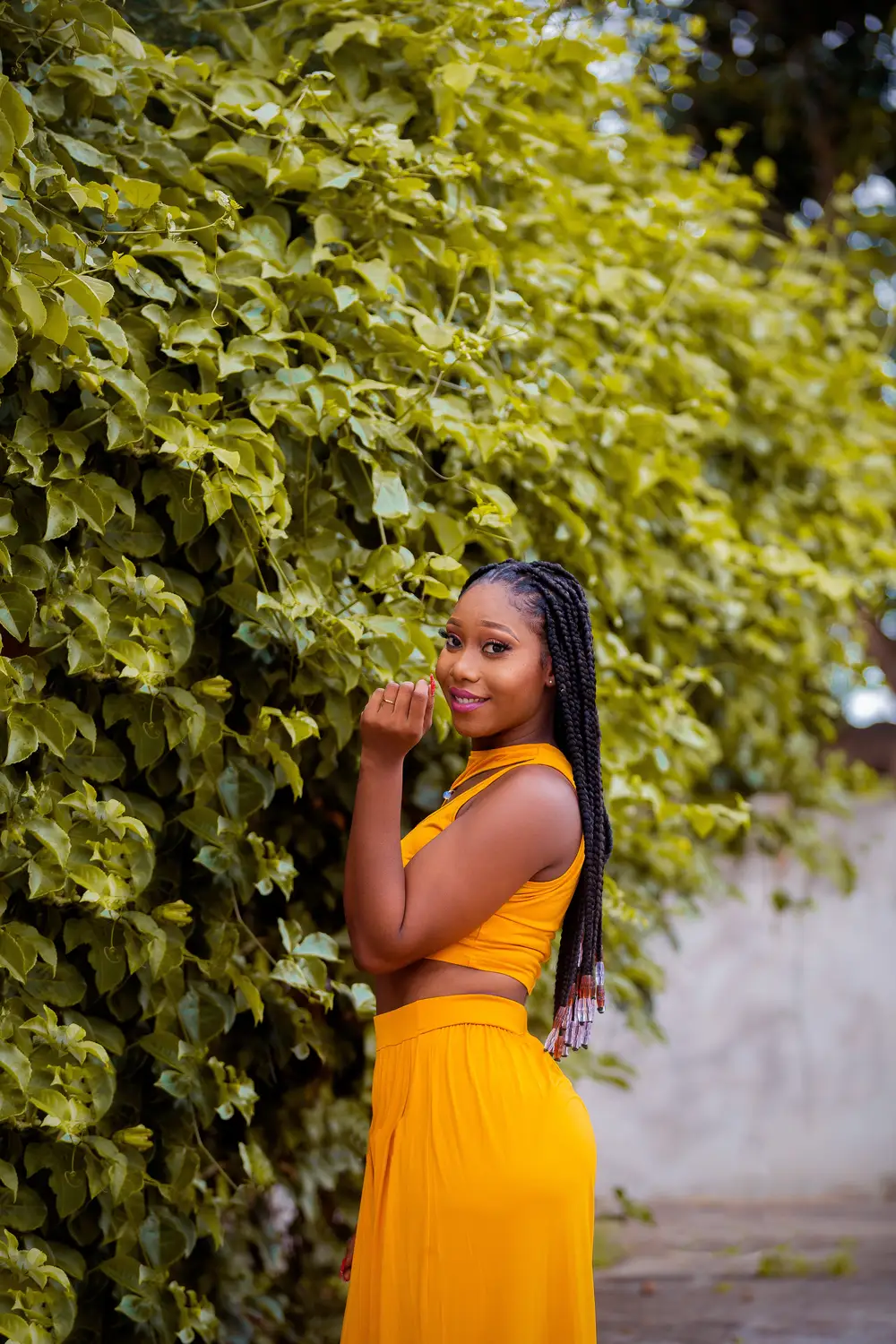 Pretty lady on long braids and yellow outfit.