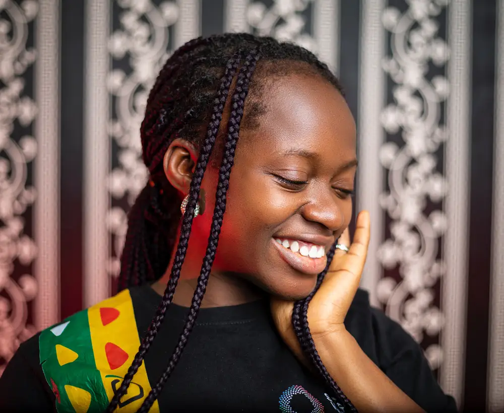 A Woman Smiling with Braided Hairstyle