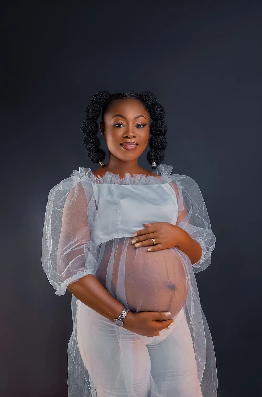 Pregnant woman on white transparent dress.