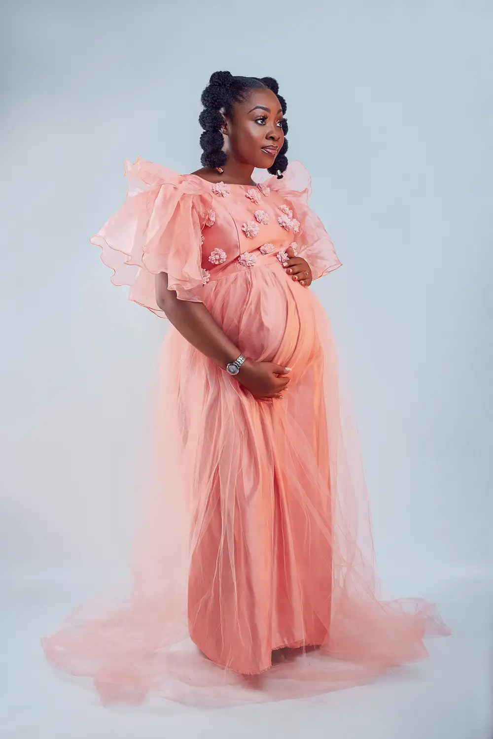 Pregnant woman on pink dress.