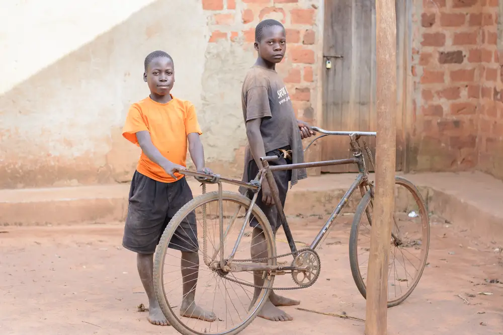 Boys holding a bicycle