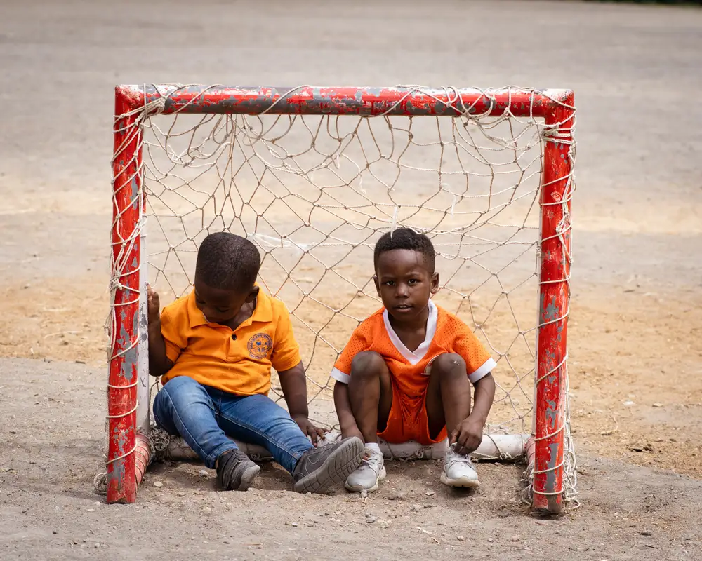 Children squatting in a goalpost
