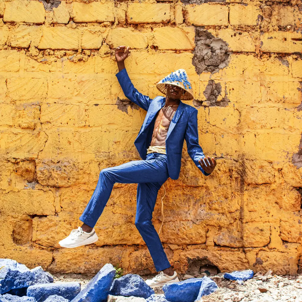 man-posing-with-an-hat-in-suit-ndtmei