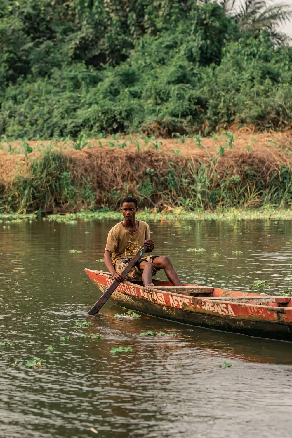 Young man paddling a boat