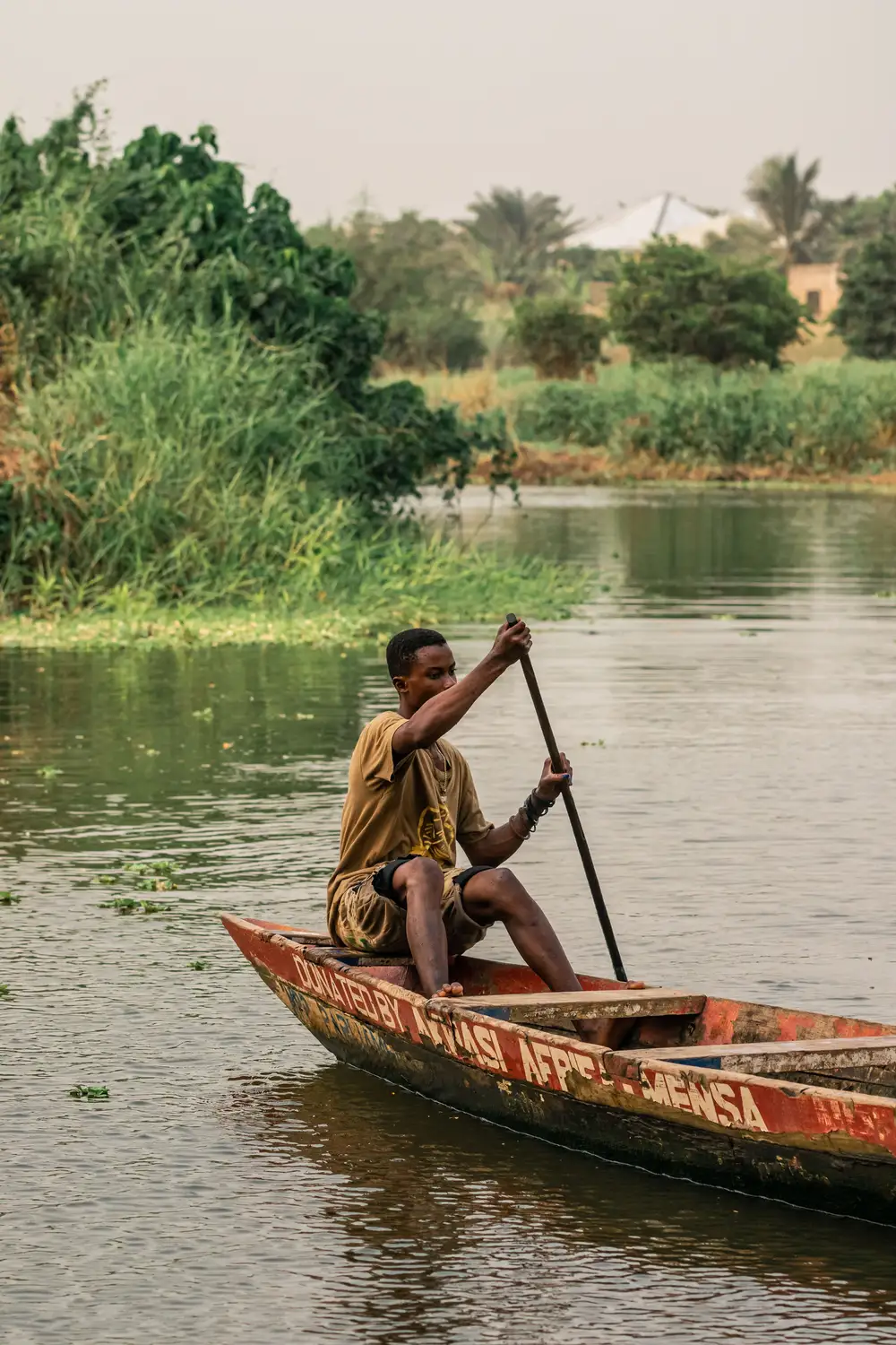 Young man paddling on a boat