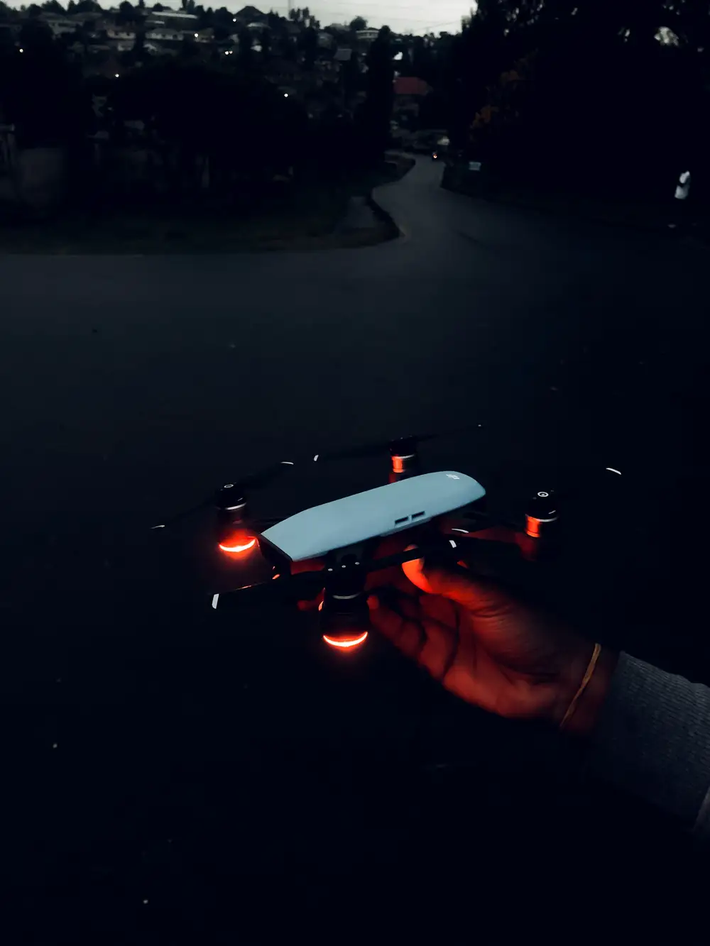 Hand holding drone in the night