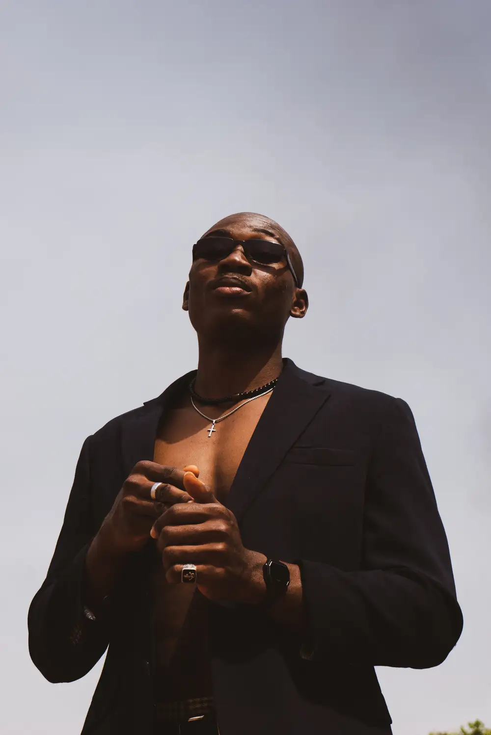 Bare chested black man in cool suit